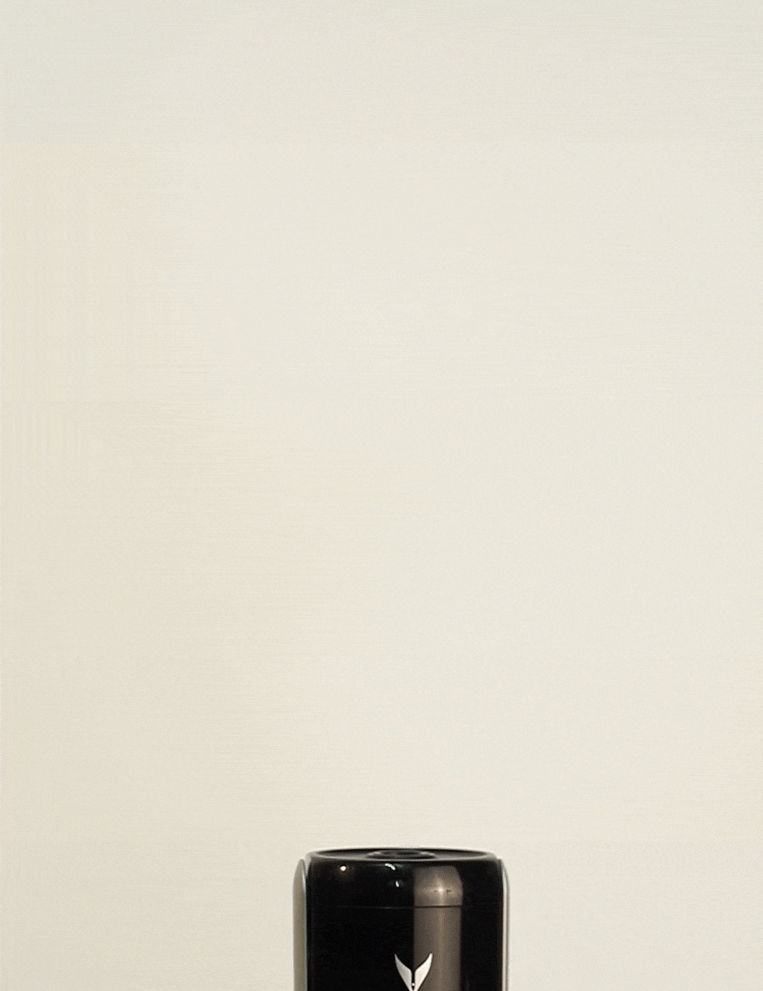Coravin wine preservation system unit with a black top and silver base against a light background.