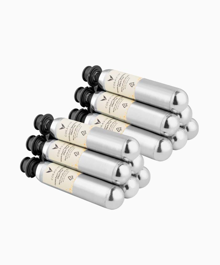 Stack of metallic silver CO2 cartridges with black tops and labeling for beverage carbonation.
