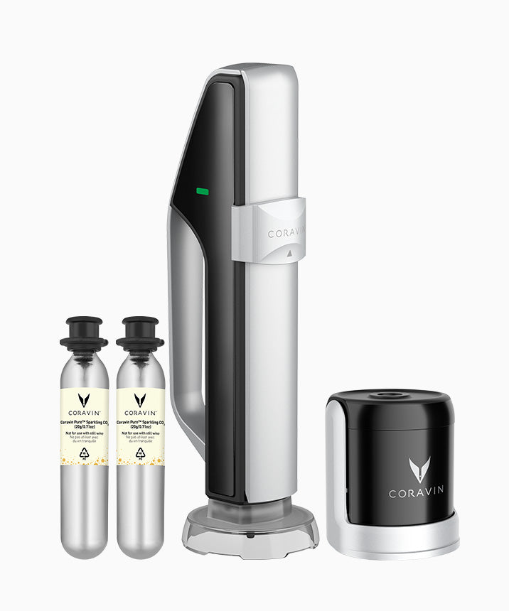Coravin wine preservation system with a stylish handle, two CO2 cartridges, and a black base unit.