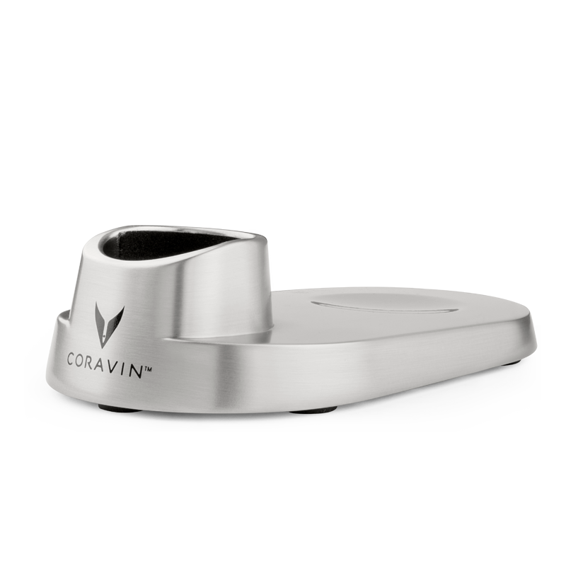 Stainless steel Coravin wine preservation system base with logo, featuring a rubber grip on top for secure placement.