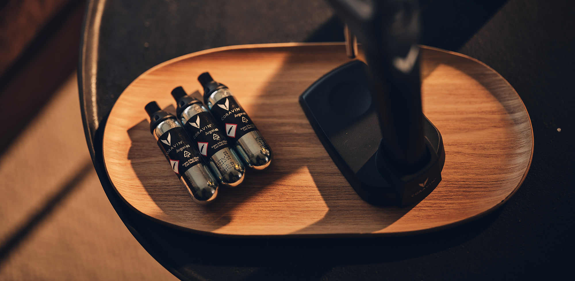 coravin capsules on wooden tray