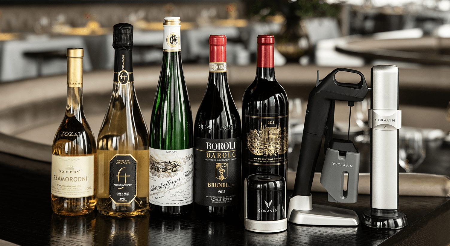 Selection of fine wines, including Szepesy Szamorodni and Boroli Barolo, with a Coravin wine preservation system.